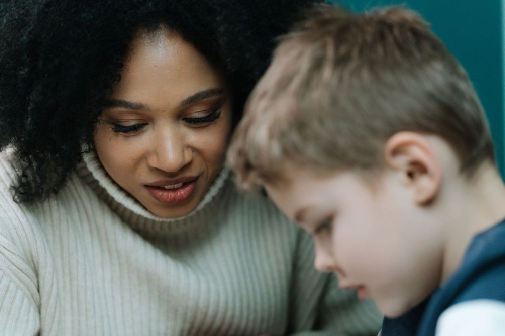 Parent supporting child with homework and learning